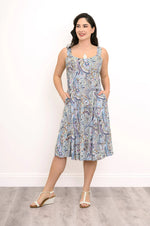 Load image into Gallery viewer, Woman wearing a sleeveless dress with a paisley pattern on a plain background
