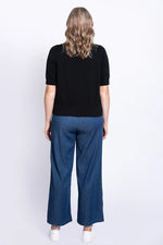 Load image into Gallery viewer, Person wearing a black top and blue pants on a white background
