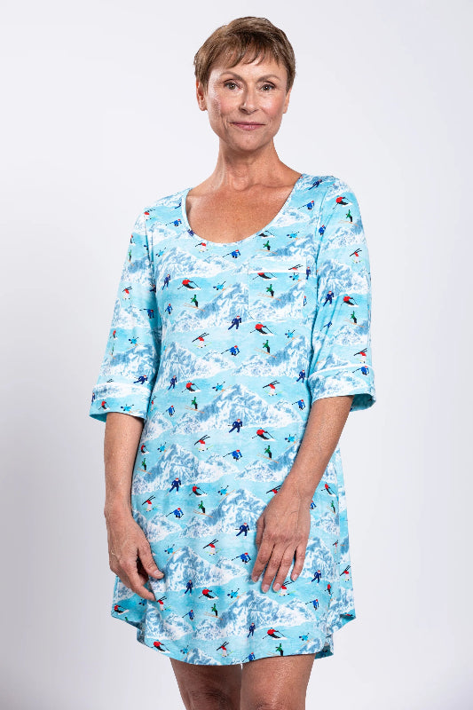Woman wearing a blue patterned dress against a white background