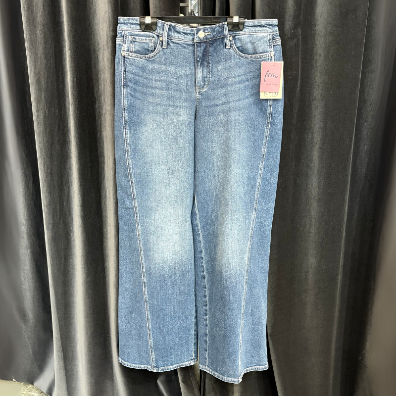 Pair of blue jeans with a tag on a black background