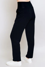Load image into Gallery viewer, Black pants worn by a person on a white background
