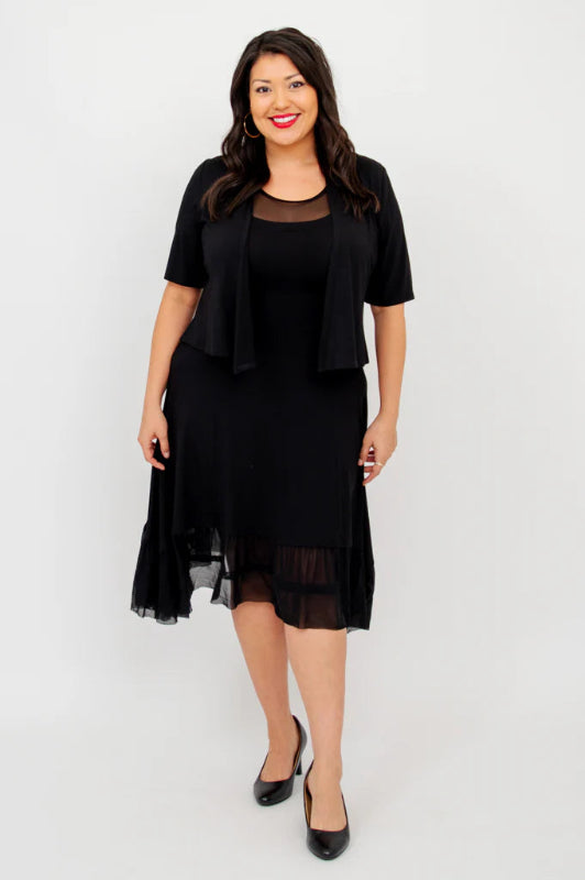 Woman wearing a black dress with a matching bolero on a white background