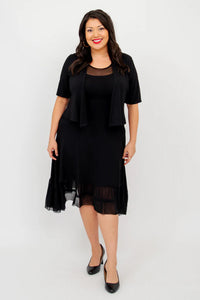 Woman wearing a black dress with a matching bolero on a white background