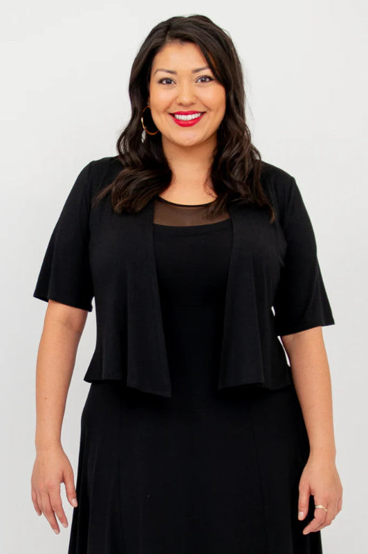 Woman wearing a black bolero with a white background