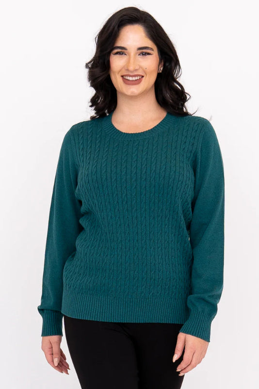 Woman wearing a teal sweater on a white background