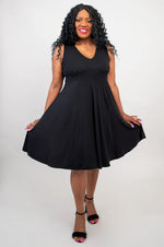 Load image into Gallery viewer, Woman wearing a black sleeveless dress on a white background
