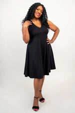Load image into Gallery viewer, Woman wearing a black sleeveless dress on a white background
