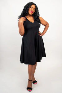 Woman wearing a black sleeveless dress on a white background