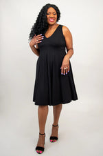 Load image into Gallery viewer, Woman wearing a black sleeveless dress on a white background
