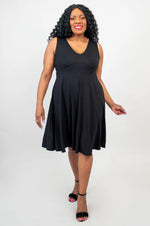 Load image into Gallery viewer, Woman wearing a black dress against a white background
