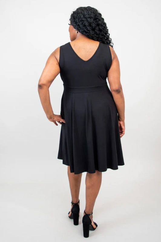 Woman wearing a black sleeveless dress on a white background