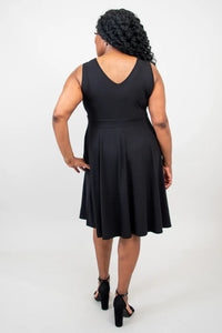 Woman wearing a black sleeveless dress on a white background
