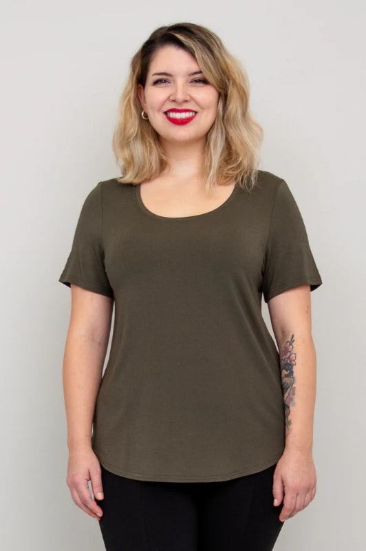 Woman wearing a Khaki Green t-shirt against a plain background