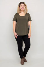 Load image into Gallery viewer, Woman wearing an olive green t-shirt and black pants against a plain background
