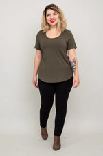 Load image into Gallery viewer, Woman wearing an olive green t-shirt and black pants on a plain background
