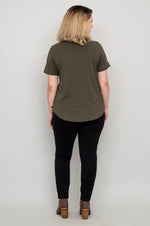 Load image into Gallery viewer, Woman wearing an olive green t-shirt and black pants against a white background
