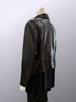 Load image into Gallery viewer, Black leather jacket on a mannequin against a gray background
